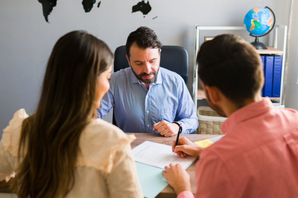 tourists buying a trip abroad with a travel agent